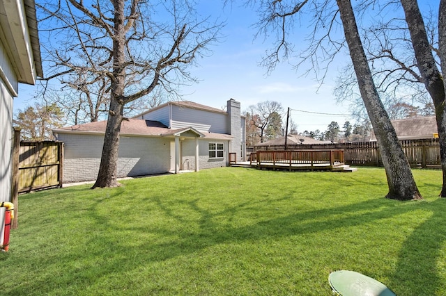 view of yard with a fenced backyard and a wooden deck