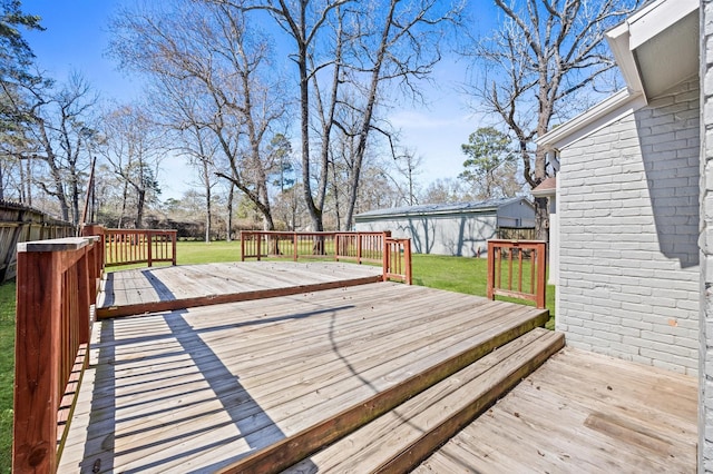 wooden deck with a lawn and fence