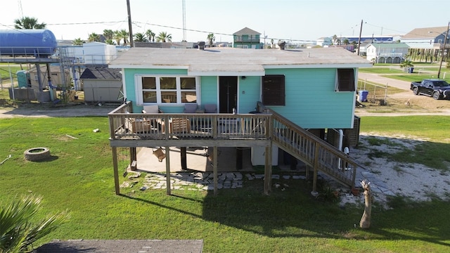 back of house with a lawn, a wooden deck, and stairs