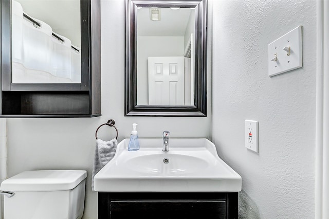 bathroom with toilet and vanity