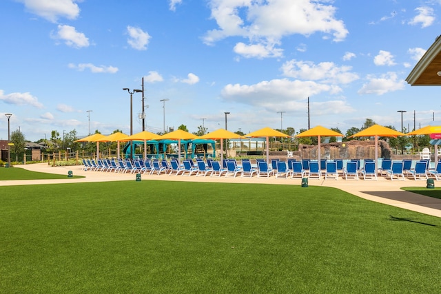 view of jungle gym featuring a lawn and fence