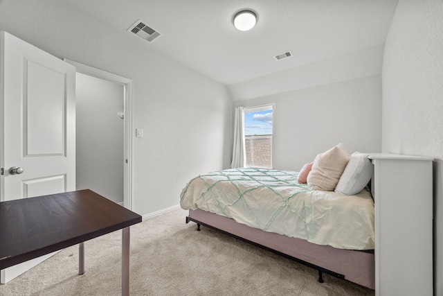 bedroom with lofted ceiling, baseboards, visible vents, and carpet flooring