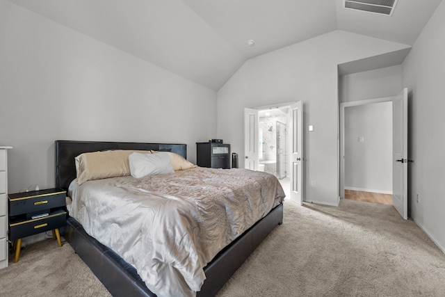 bedroom featuring baseboards, visible vents, connected bathroom, light colored carpet, and vaulted ceiling