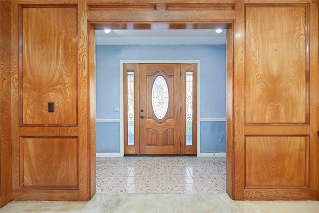 foyer featuring light tile patterned flooring and baseboards