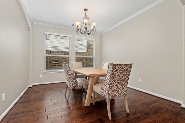 dining space featuring dark wood-style floors, baseboards, an inviting chandelier, and crown molding