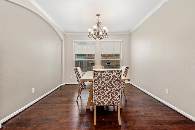 dining space with ornamental molding, dark wood-type flooring, an inviting chandelier, and baseboards