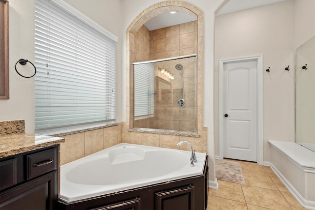 full bathroom featuring a tile shower, a garden tub, vanity, and tile patterned floors