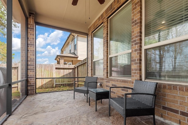 sunroom with a healthy amount of sunlight and ceiling fan