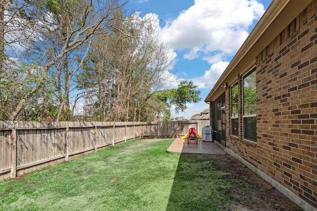 view of yard with a patio area and a fenced backyard