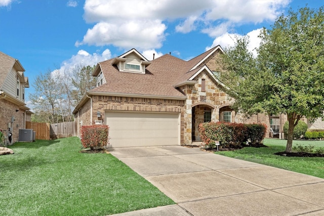 view of front of property featuring central air condition unit, stone siding, driveway, roof with shingles, and a front lawn