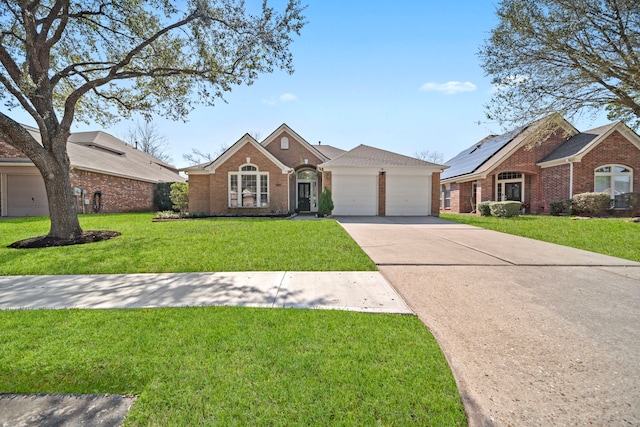 view of front of home with a garage, concrete driveway, brick siding, and a front yard