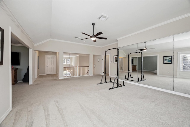 workout room featuring visible vents, vaulted ceiling, carpet flooring, and crown molding