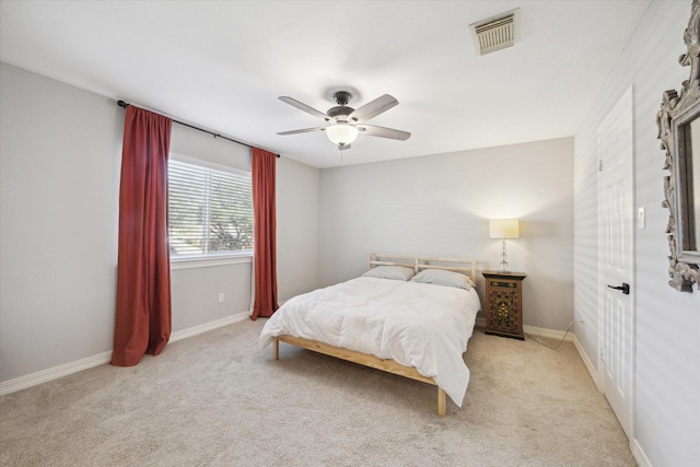 bedroom featuring visible vents, a ceiling fan, baseboards, and carpet floors