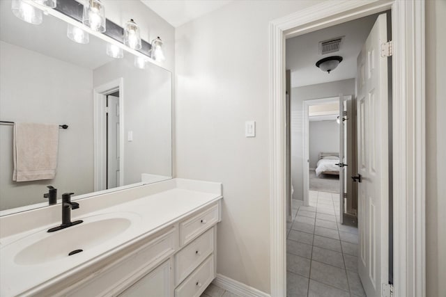 bathroom featuring tile patterned floors, visible vents, vanity, and baseboards