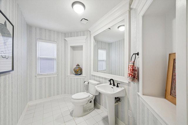 half bath featuring tile patterned flooring, visible vents, toilet, and wallpapered walls