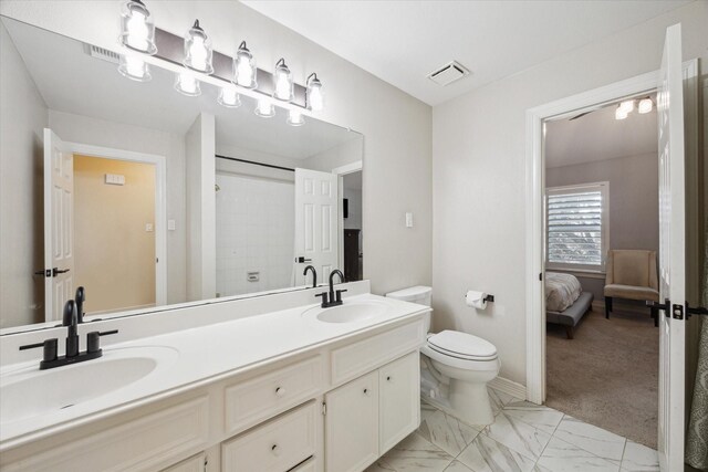 bathroom featuring a sink, visible vents, toilet, and marble finish floor