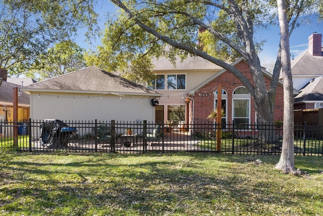 view of front of property with brick siding, a lawn, and fence