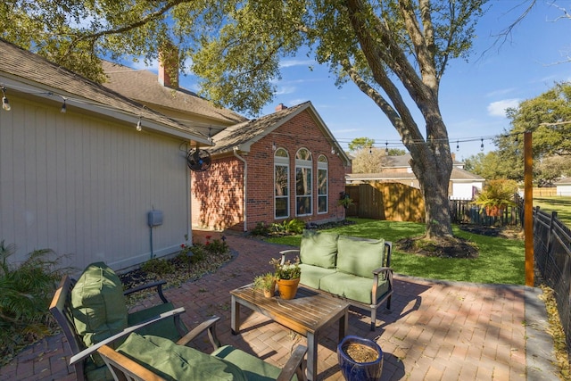 view of patio featuring an outdoor living space and a fenced backyard
