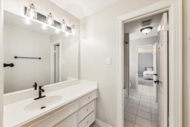 full bath featuring vanity, tile patterned floors, toilet, visible vents, and baseboards