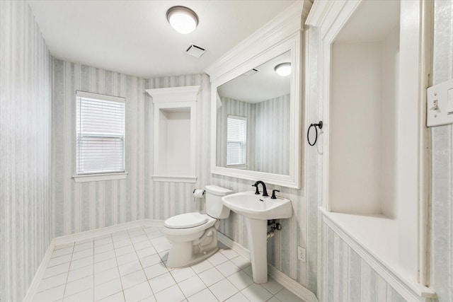 bathroom with tile patterned flooring, wallpapered walls, a wealth of natural light, toilet, and visible vents