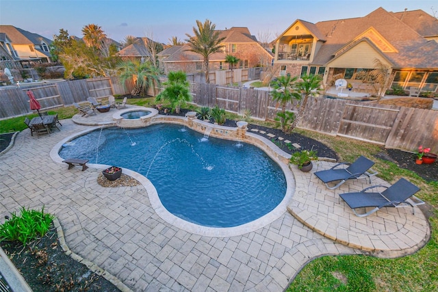 view of swimming pool with an outdoor fire pit, a pool with connected hot tub, a fenced backyard, and a patio