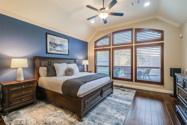 bedroom with crown molding, visible vents, vaulted ceiling, and wood finished floors