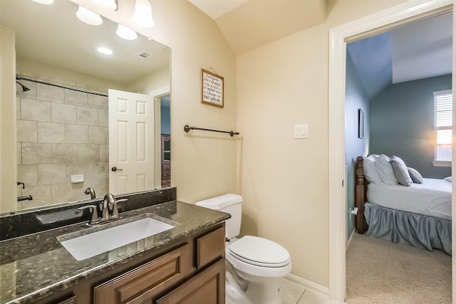 ensuite bathroom with baseboards, visible vents, toilet, vaulted ceiling, and vanity