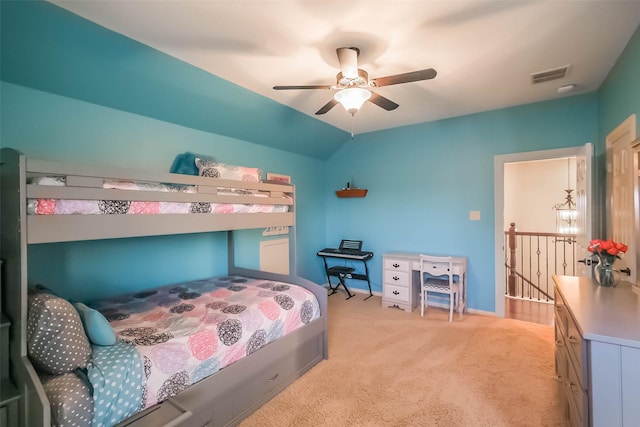 bedroom featuring lofted ceiling, a ceiling fan, visible vents, and light colored carpet