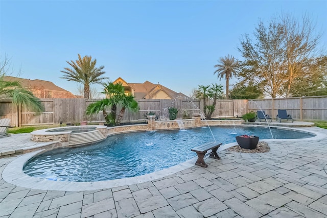 view of swimming pool with a patio, a fenced backyard, and a pool with connected hot tub