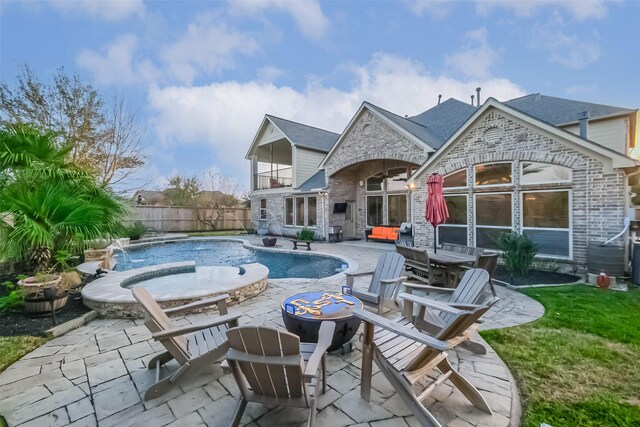 rear view of house featuring a fenced in pool, brick siding, a shingled roof, a patio area, and fence