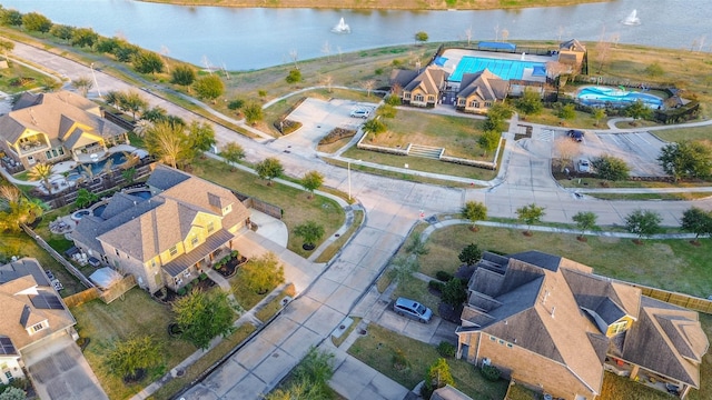 drone / aerial view featuring a water view and a residential view