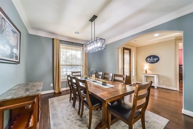 dining space featuring visible vents, crown molding, arched walkways, and dark wood-type flooring