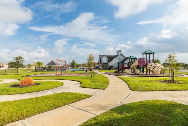 view of home's community with playground community and a lawn