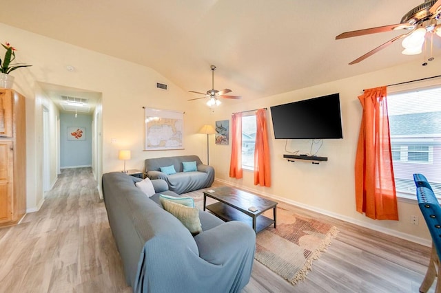 living room featuring lofted ceiling, light wood-style floors, attic access, and visible vents