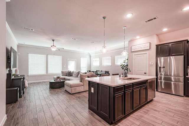 kitchen featuring light wood-type flooring, visible vents, appliances with stainless steel finishes, and a sink