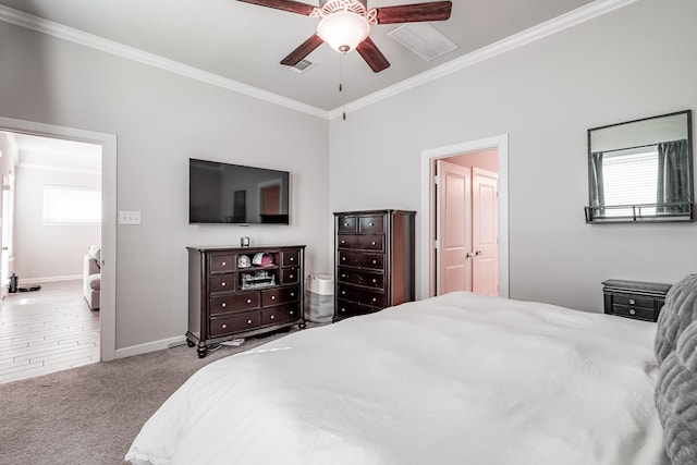 carpeted bedroom featuring visible vents, multiple windows, and ornamental molding