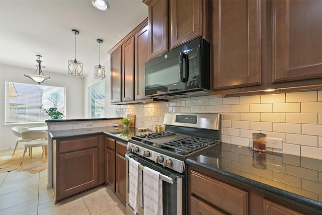 kitchen with backsplash, stainless steel range with gas cooktop, black microwave, a peninsula, and light tile patterned flooring