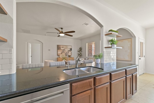 kitchen with visible vents, open shelves, dark stone countertops, a sink, and dishwasher