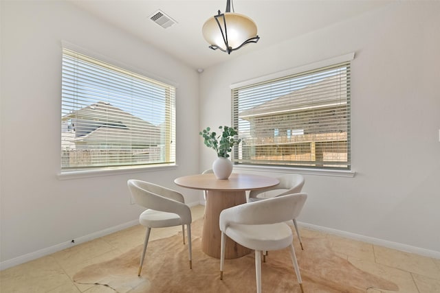 dining room with tile patterned floors, baseboards, and visible vents