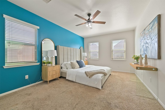 carpeted bedroom with baseboards and ceiling fan