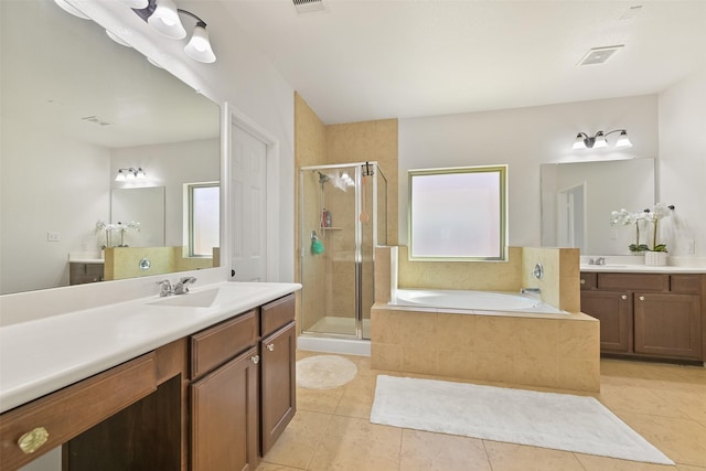 bathroom with tile patterned floors, visible vents, a stall shower, a sink, and a bath