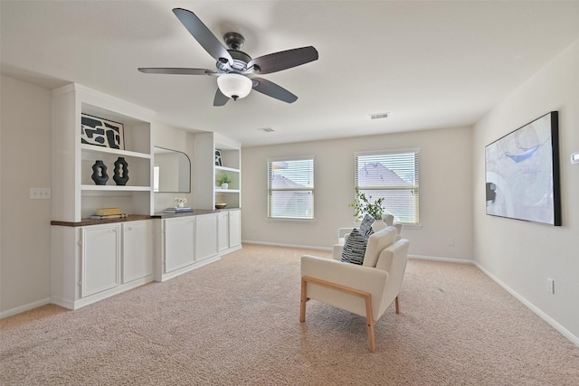 sitting room featuring visible vents, baseboards, and light colored carpet