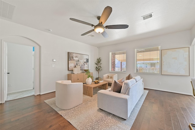 living area featuring dark wood finished floors and visible vents