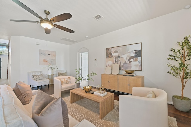 living room with a ceiling fan, wood finished floors, and visible vents