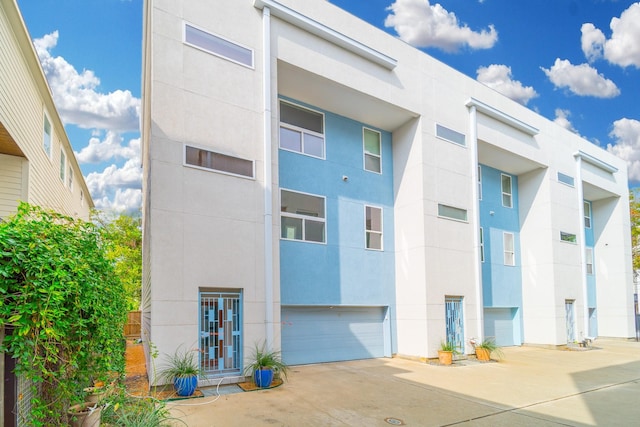 view of building exterior with driveway and a garage