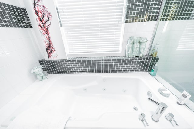 bathroom featuring a tub with jets