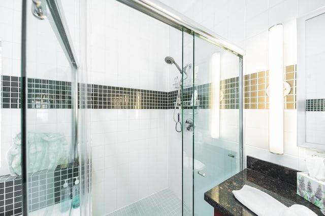 bathroom with a stall shower and vanity