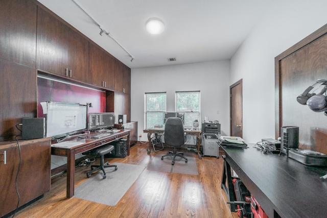 home office featuring light wood finished floors, visible vents, and track lighting