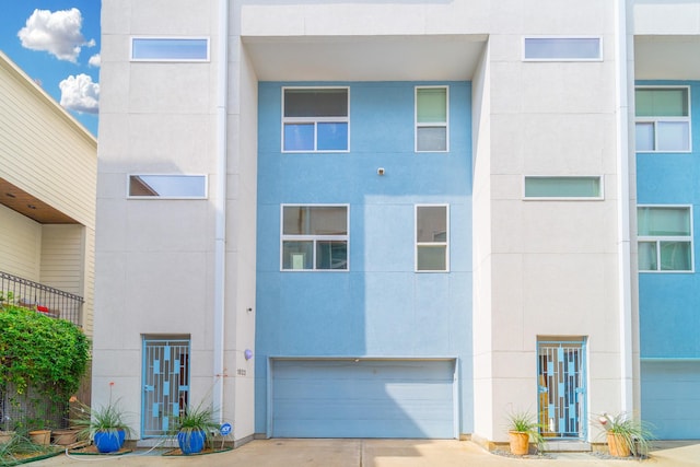 view of building exterior with a garage and concrete driveway