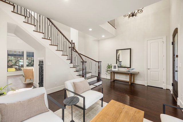 foyer with recessed lighting, a high ceiling, baseboards, stairs, and dark wood-style floors